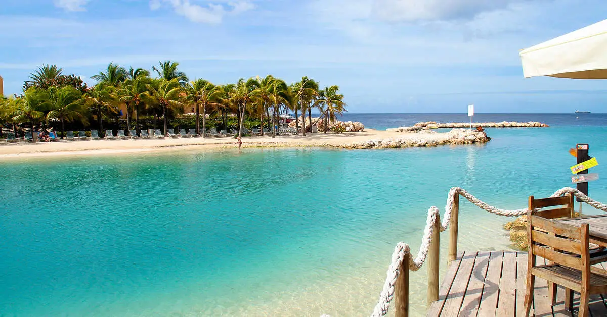 Rustig, ondiep water in de lagune van Mambo Beach